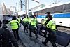 Police in riot gear patrol the streets in front of the Constitutional Court in Jongno District, central Seoul on Thursday. [NEWS1]