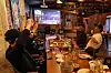 People watch coverage of the vote count for Korea's 21st presidential election at a bar in Dong District, Gwangju, on June 3. [YONHAP]