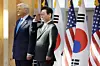 Korean President Lee Jae Myung, right, raises his hand in salute during a welcome ceremony for U.S. President Donald Trump at the Gyeongju National Museum on Oct. 29. [JOINT PRESS CORPS]