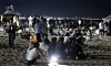 Visitors to a beach in Gangneung, Gwangwon, rest as a tropical night hit the region on July 27. [YONHAP]