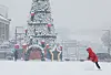 A child makes a snowball near Hwaseong Haeunggung in Suwon, Gyeonggi, on Christmas that fell on Monday. Many parts of the country, including Seoul and Gyeonggi, were piled under snow on Monday. [YONHAP]
