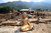 A Buddha statue sits near the Gyeongho River rest area in Oesong-ri, Sinan-myeon, Sancheong County, South Gyeongsang, as search operations continue for missing persons following torrential rain and landslides on July 22. [NEWS1]
