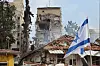 Israeli rescue teams work at the site of a damaged residential area after Iranian ballistic missiles hit Rehovot, central Israel, on June 15. [EPA/YONHAP]