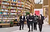 Chung Yong-jin and colleagues walk through a library at Starfield Village Unjeong in Paju.