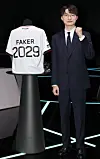 T1’s Faker, whose real name is Lee Sang-hyeok, poses next to a uniform with his name during a press conference in Jongno District, central Seoul, on Dec. 18. [YONHAP]