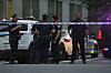 New York Police officers gather at the scene on 52nd Street outside a Manhattan office building where two people were shot, including a New York police officer, in New York City on July 28. [AP/YONHAP]