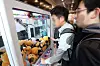 Young men play with a claw machine on April 11, 2017. [JOONGANG ILBO]