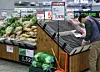 A staff cleans up the vegetable section at a retail store in Seoul on Nov. 10. [YONHAP]