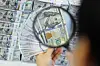 An employee inspects dollar bills at Hana Bank's Counterfeit Notes Response Center in Jung District, central Seoul, on Dec. 19, when the won-dollar exchange rate soared above the 1,450-won-per-dollar mark for the first time in 15 years and nine months. [YONHAP]