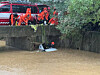 Firefighters work to rescue a driver trapped in a vehicle flooded with rainwater near a bridge in Gimpo, Gyeonggi, on Aug. 13. [YONHAP]