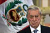 Peruvian writer Mario Vargas Llosa, winner of the 2010 Nobel Prize in Literature, stands in front of the Peruvian flag during the ceremony to invest him with the ″Order of the Arts and Letters″ at the presidential palace in Lima on Dec. 15, 2010. [AFP/YONHAP]