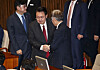 President Yoon Suk Yeol, left, shakes hand with Democratic Party Chairman Lee Jae-myung before making a parliamentary speech on next year’s budget at the National Assembly in Yeouido, western Seoul, on Tuesday. [JOINT PRESS CORPS]