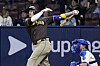 San Diego Padres' Manny Machado, left, hits a three-run home run as Los Angeles Dodgers catcher Will Smith watches during Game 2 of the Seoul Series between the San Diego Padres and Los Angeles Dodgers at Gocheok Sky Dome in western Seoul on Thursday.  [AP/YONHAP]