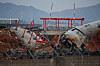 The wreckage of the Jeju Air aircraft that slid off the runway and crashed at Muan International Airport lies near a concrete structure it crashed into, in Muan, South Jeolla, on Dec. 30, 2024. [REUTERS/YONHAP]