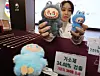 A Korea Customs Service official displays a counterfeit Labubu keyring that tested positive for toxic chemicals, alongside a genuine version of the toy, during a press briefing held in Gangnam District, southern Seoul, on Nov. 5. [YONHAP]