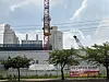 A data center under construction in Ilsan, Gyeonggi Province, operated by Magna PFV, is seen on July 28. Protest banners tied to roadside trees were put up by a local opposition committee. [LEE JAE-LIM]