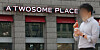 A passerby walks in front of a A Twosome Place store in Seoul on March 24. [YONHAP]