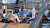 Members of a government joint investigation team, including Transport Ministry’s Aviation and Railway Accident Investigation Board (Araib), inspect the area around the tail wing of the crashed passenger plane at the sie of the Jeju Air crash at Muan International Airport on Jan. 8. [YONHAP]