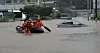 Firefighters rescue individuals who were trapped in a building following a nearby road flooding in Paju on July 18. [NEWS1]