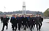 Democratic Party leader Lee Jae-myung, center, walks out from the May 18th National Cemetery in Gwangju on March 18. [NEWS1]