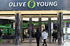 Shoppers enter an Olive Young store in Myeong-dong, central Seoul, on Jan. 9. [YONHAP]