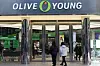 Shoppers enter an Olive Young store in Myeong-dong, central Seoul, on Jan. 9. [YONHAP]