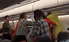 Chinese passengers argue over noise and break into a brawl on board a flight on July 21. [SCREEN CAPTURE]
