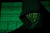 A projection of cyber code on a hooded man is pictured in this illustration picture taken on May 13, 2017. [REUTERS/YONHAP]