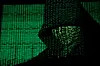 A projection of cyber code on a hooded man is pictured in this illustration picture taken on May 13, 2017. [REUTERS/YONHAP]