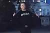 Elon Musk flashes his t-shirt that reads ″DOGE″ to the media as he walks on South Lawn of the White House, in Washington, on March 9. [AP/YONHAP]