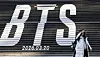 A tourist takes photos in front of a promotional display for BTS’s fifth full-length album, set up on the steps of Sejong Center for the Performing Arts in central Seoul on Jan. 22. [NEWS1]