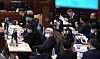 Former President Yoon Suk Yeol, right top, reviews documents as he takes his seat at the Seoul Central District Court in Seocho District, southern Seoul, on Jan. 13, ahead of the second sentencing hearing on charges of leading an insurrection. [SEOUL CENTRAL DISTRICT COURT]