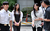 NewJeans member Danielle, center left, and Minji appear at Seoul Central District Court in southern Seoul on Aug. 14. [NEWS1]