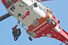 A helicopter rescues evacuees from the rooftop of a building at a construction site in Busan on Feb. 14. [NEWS1]