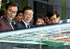 DP leader Lee Jae-myung at the center is listening to Busan officials explanations on how its historic North Port will be rebuilt into new port, on March 6. [YONHAP]