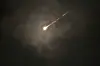 The trail of a projectile is seen through the clouds following a missile alert after launches from Iran, in Jerusalem, early Monday, June 16, 2025. [AP/YONHAP]