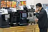 A visitor looks around coffee machines at a cafe and desert fair held in Coex Magok Le West in Gangseo District, western Seoul on May 8. [YONHAP]
