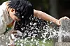 A child cools off from the heat with water at a park in Buk District in Gwangju on June 23. [NEWS1]