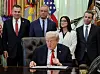 U.S. President Donald Trump looks at documents on his desk, as U.S. Rep. Richard Hudson, U.S. Secretary of Health and Human Services Robert F. Kennedy Jr., U.S. Secretary of Labor Lori Chavez-DeRemer and U.S. Food and Drug Administration (FDA) Commissioner Dr. Marty Makary look on, during an event in the Oval Office at the White House in Washington on Oct. 16. [REUTERS/YONHAP]