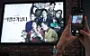 A moviegoer takes a photo of the poster for the film ″No Other Choice,″ directed by Park Chan-wook, at a theater in Seoul on Sept. 25. [NEWS1]