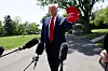 U.S. President Donald Trump holds a cap with the words ″Gulf of America″ embroidered as he speaks to the media before boarding Marine One to depart for Michigan to attend a rally to celebrate his first 100 days in office, from the South Lawn of the White House in Washington, D.C., on April 29, 2025. [REUTERS/YONHAP]