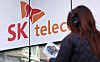 A pedestrian walks by an SK Telecom store in Seoul on Nov. 21. [NEWS1]