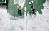 Volunteers from the Game Rating and Administration Committee paint rooftops white as part of a “cool roof” project in Suyeong District, Busan, on May 30, to block heat and reduce air-conditioning costs during the summer. [JOONGANG ILBO]