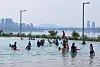 Visitors play in the water at a pool in Jamsil Hangang Park in Songpa District, southern Seoul, on June 19, 2024. [YONHAP]