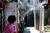 Cooling mist is sprayed in a jjokbang, or subdivided housing area, in Jongno District, central Seoul, on June 11, as early summer heat sets in. [JOONGANG ILBO]