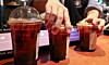 A worker organizes disposable plastic cups filled with coffee at a cafe in Seoul on Dec. 18. [NEWS1]