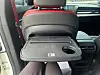 A small table is mounted to the back of the front seats so that passengers in the rear seats can easily get some work done or set up their tablets. [SARAH CHEA]
