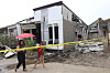Two women walk past a damaged house after a strong earthquake in Davao City, southern Philippines on Friday Oct. 10. [AP/YONHAP]