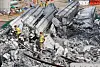 Firefighters try to rescue injured workers who were trapped under the rubble at the bridge construction site collapse in Anseong, Gyeonggi, on Feb. 25. [YONHAP]