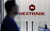A person passes by Nextrade (NXT) logo at NXT's headquarters in Yeouido, western Seoul, on March 3. [YONHAP]